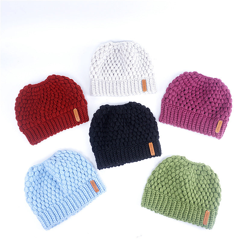 Europe and the United States new knit hat winter ladies horsetail hat autumn and winter earmuffs wool hat fashion labeling empty top hat